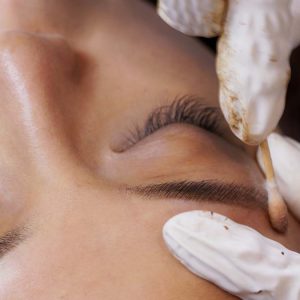 Beautician specialist of permanent makeup making brow microblading tattooing make up