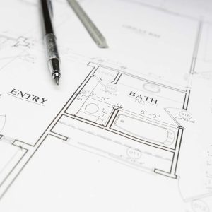 Engineer Pencil and Ruler Resting on Custom House Plans.