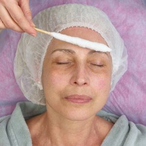 Face cryomassage, adult woman. Cosmetologist using liquid nitrogen. The science of rejuvenation.