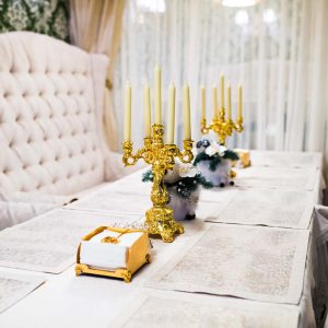 Festive table with menu, candles and decorations for New Year or Christmas corporate party celebration. Winter holildays celebration concept