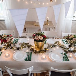 A top view of table set for a meal indoors in a room on a party, a wedding or family celebration.